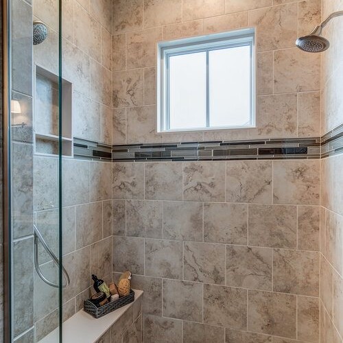 A bathroom with tile floors and a glass shower in a custom home.