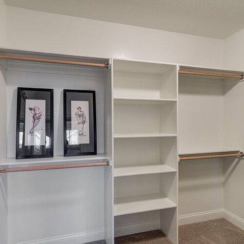 A walk in closet with shelves and mirrors, expertly crafted by a custom home builder in Indianapolis Indiana.