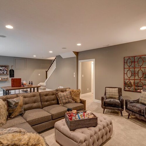 A living room with a couch and a coffee table in a luxury custom home in Carmel Indiana.