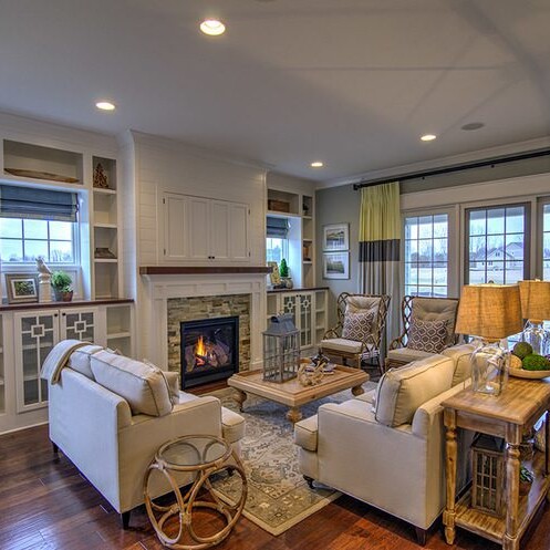A luxurious living room adorned with hardwood floors and a cozy fireplace.