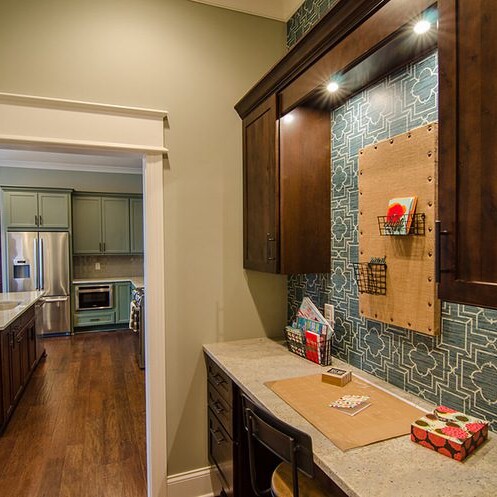 A kitchen with wooden cabinets and a counter top for new homes for sale in Carmel Indiana.