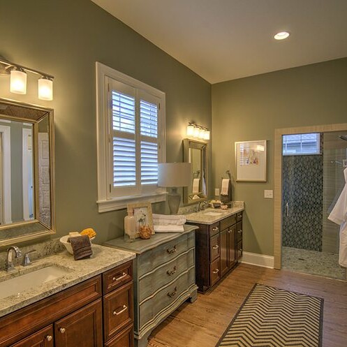 A luxury bathroom with two sinks and a mirror in a custom home built by a luxury custom home builder in Westfield Indiana.