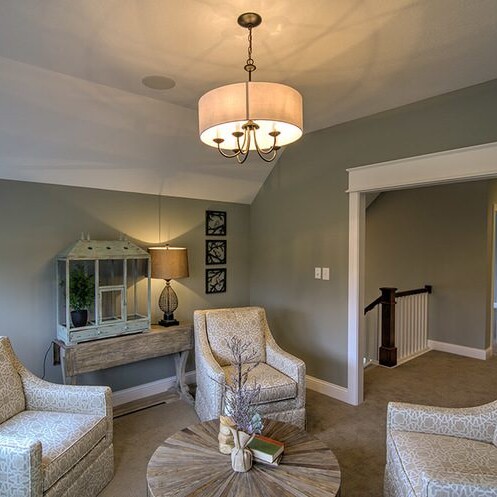 A living room with two chairs and a table, designed and built by a luxury custom home builder in Westfield Indiana.