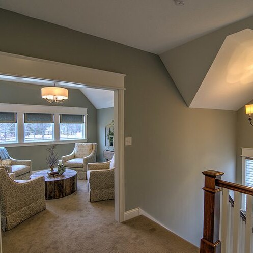 A new home for sale in Carmel Indiana, featuring a living room with a staircase leading to another living room.