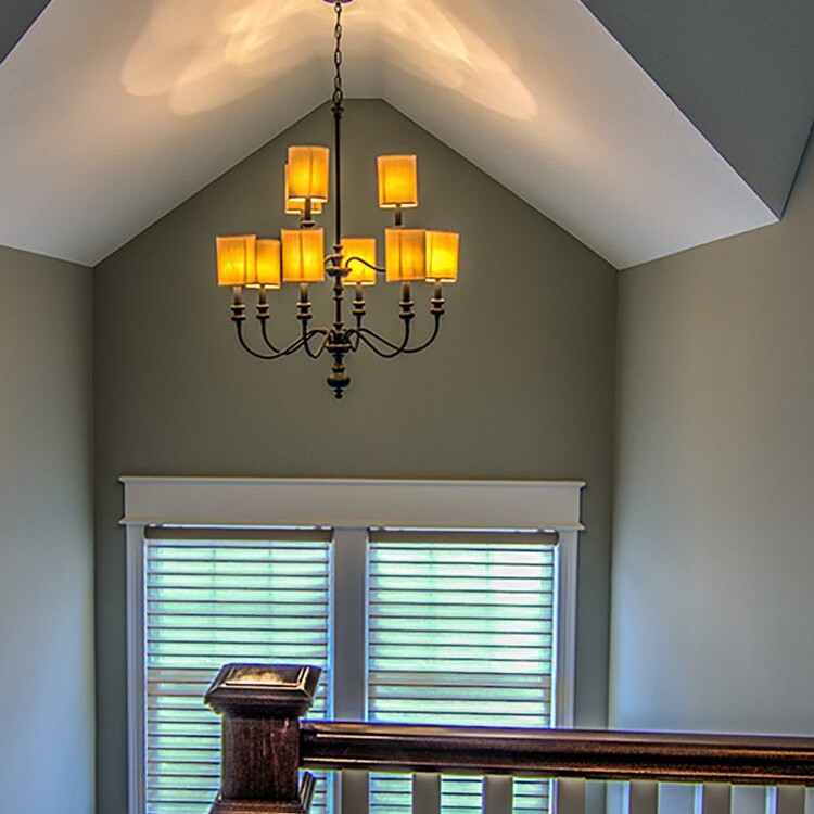 A custom home in Fishers Indiana featuring a staircase with a beautiful light fixture.