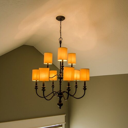 A luxurious room with a chandelier hanging from the ceiling.