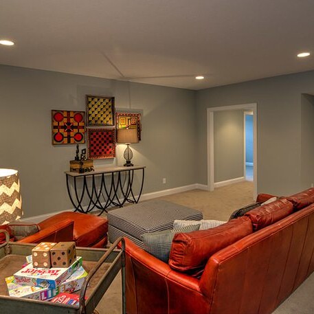 A living room with couches and a coffee table in a custom home built by a leading Custom Home Builder in Carmel Indiana.