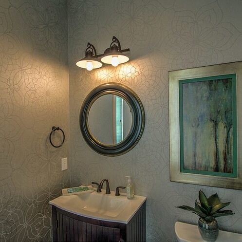 A bathroom with a sink and a mirror, designed and built by a Custom Home Builder in Carmel Indiana.