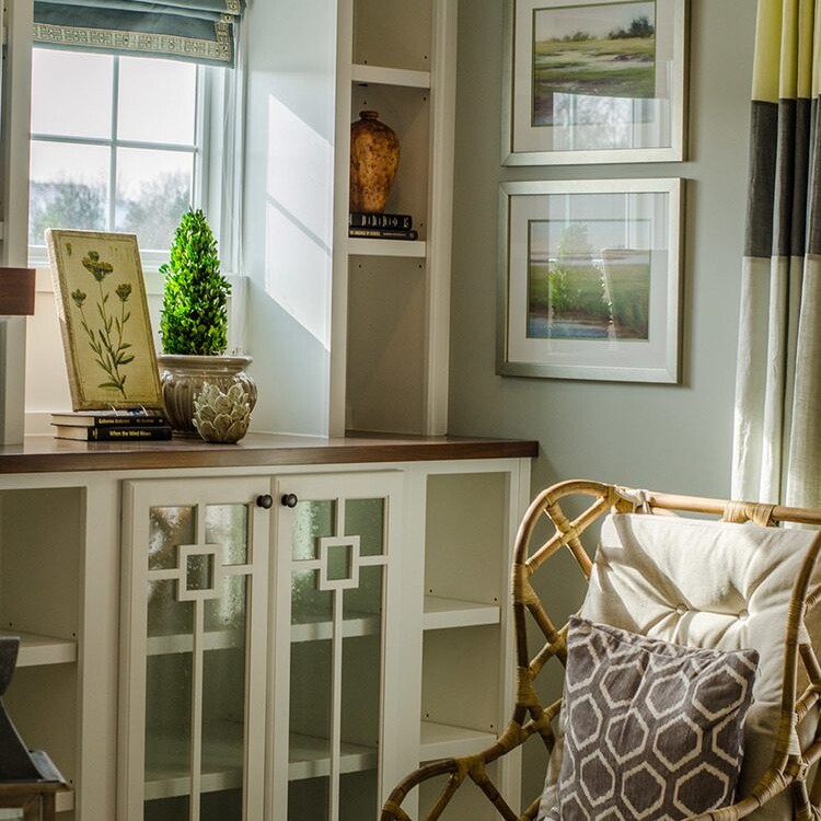 A luxurious living room with wicker chairs and a window.