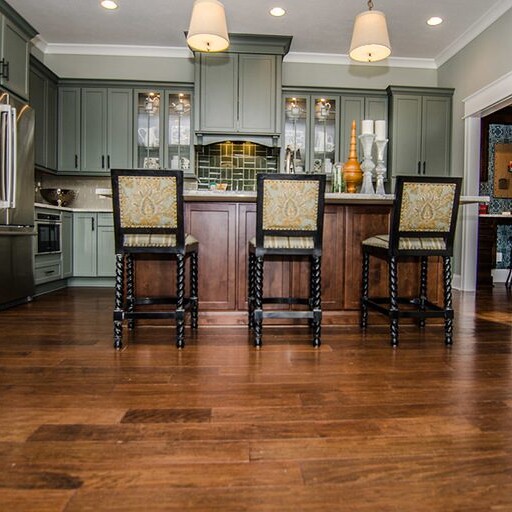 A kitchen with hardwood floors that embodies the warmth and elegance of a custom home.