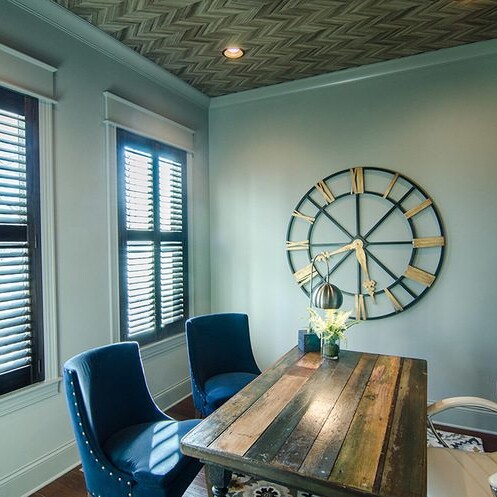         Description: A home office with blue chairs and a clock, furnished by a Luxury custom home builder in Carmel Indiana.
