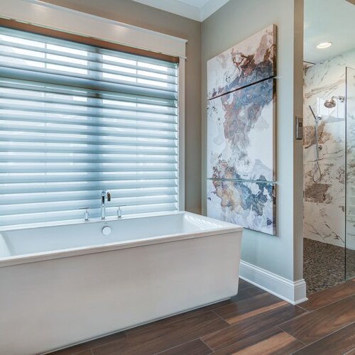 A luxurious bathroom with a tub and shower, ideal for custom home builders in Carmel, Indiana.