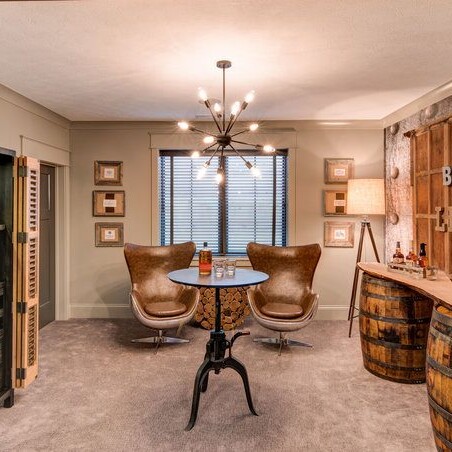 A room with a bar and a wooden barrel, perfect for new home construction or homes for sale in Indiana.