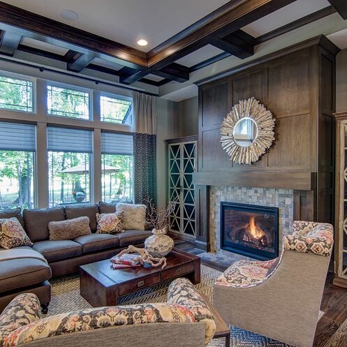 A custom-built living room with a fireplace and couches in a new home construction in Indianapolis, Indiana.