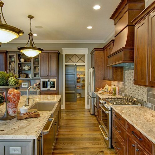 A custom kitchen with wood cabinets and granite counter tops in a new home for sale in Carmel, Indiana.