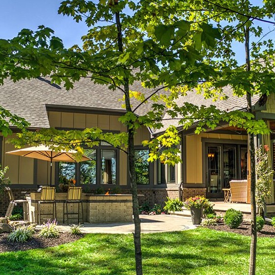 A new home with a large yard and patio located in Carmel, Indiana.