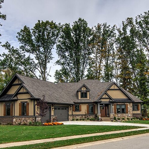A home in a neighborhood with trees and a driveway, located in Carmel, Indiana.