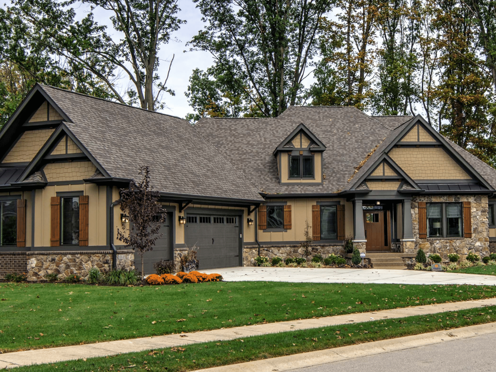 A newly constructed home in Carmel, Indiana with a front porch and a driveway.
