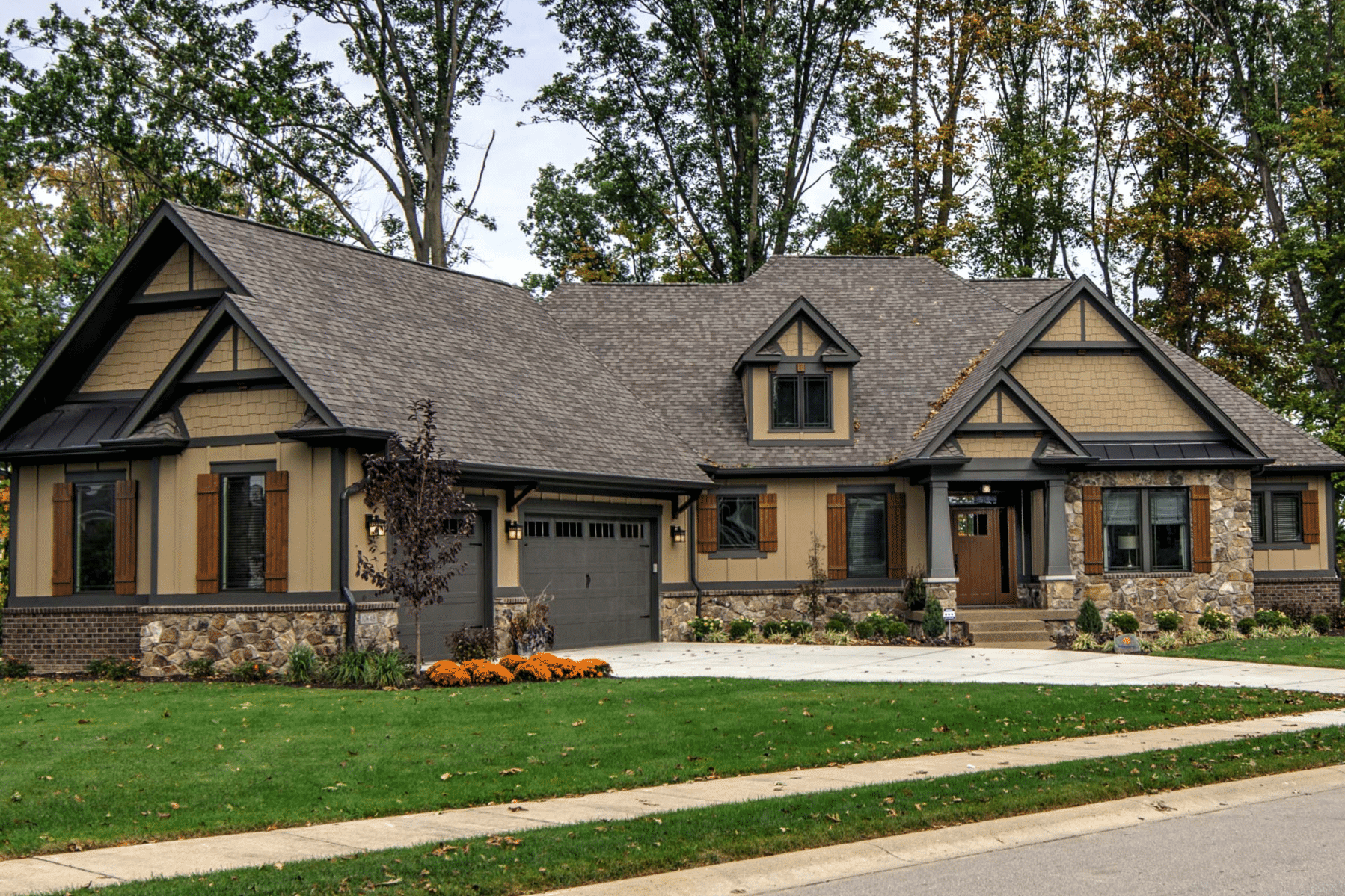 A newly constructed home in Carmel, Indiana with a front porch and a driveway.