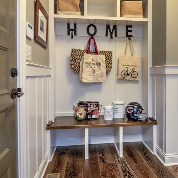 A mudroom with a coat rack and a bag hanging on the wall, created by a Custom Home Builder in Indianapolis Indiana.