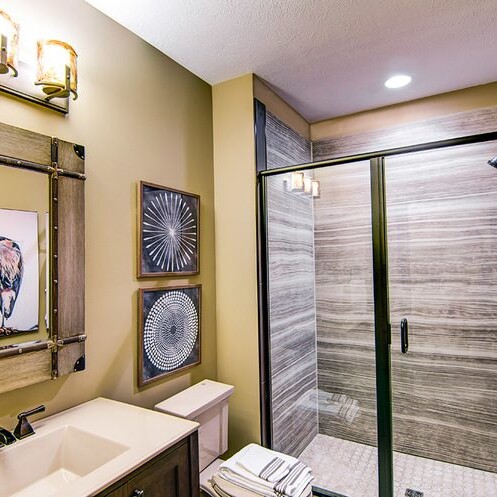 A luxury bathroom with a walk-in shower and a sink.