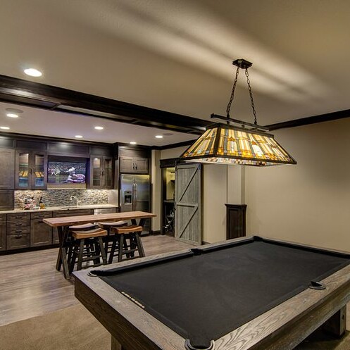 A luxurious game room featuring a pool table and bar, crafted by a renowned custom home builder in Westfield and Carmel, Indiana.