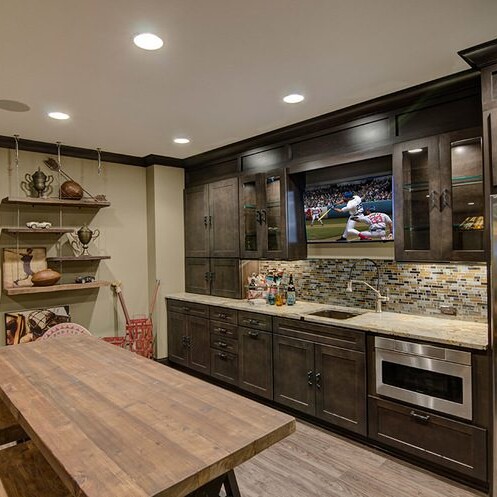 A custom kitchen with a table and chairs, featuring a TV.