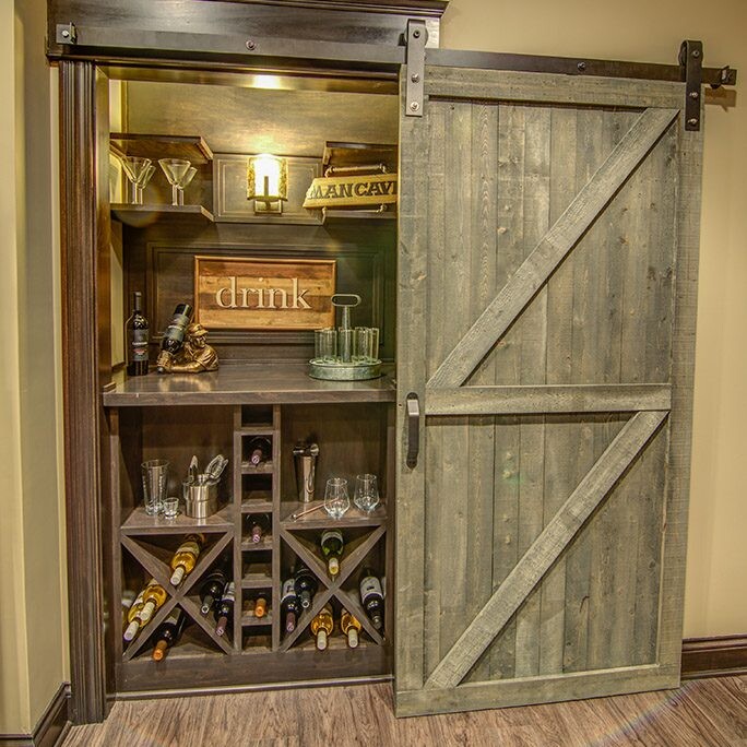 A custom barn door with wine racks and a wine cellar in a new home for sale in Carmel, Indiana.