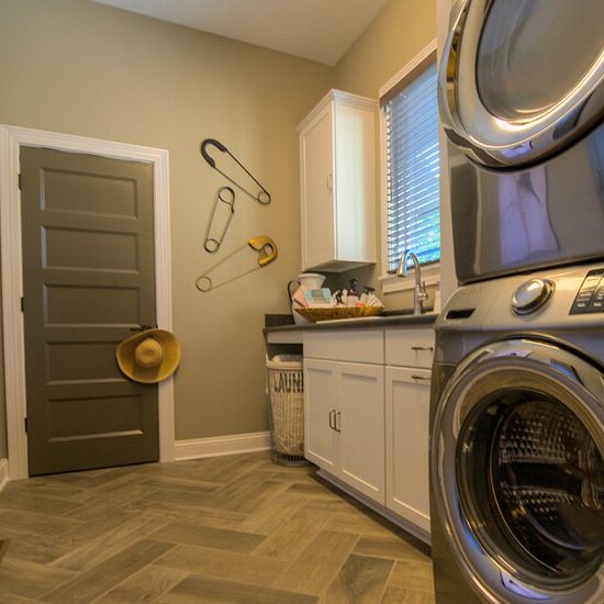 A modern laundry room equipped with a new washer and dryer for the convenience of residents.