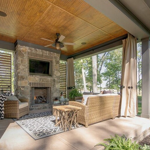 A stunning outdoor living area with a fireplace and a TV, perfect for enjoying the beautiful scenery.