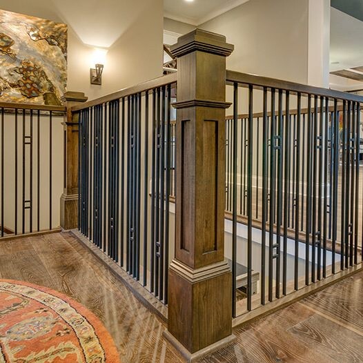 A home with a staircase featuring wrought iron railings, perfect for those looking for new homes in Carmel, Indiana or custom home construction in Indianapolis, Indiana.