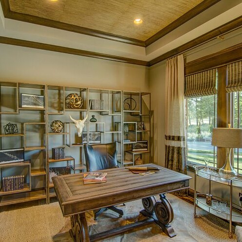A home office with a desk and bookshelf, located in a custom home in Westfield, Indiana.