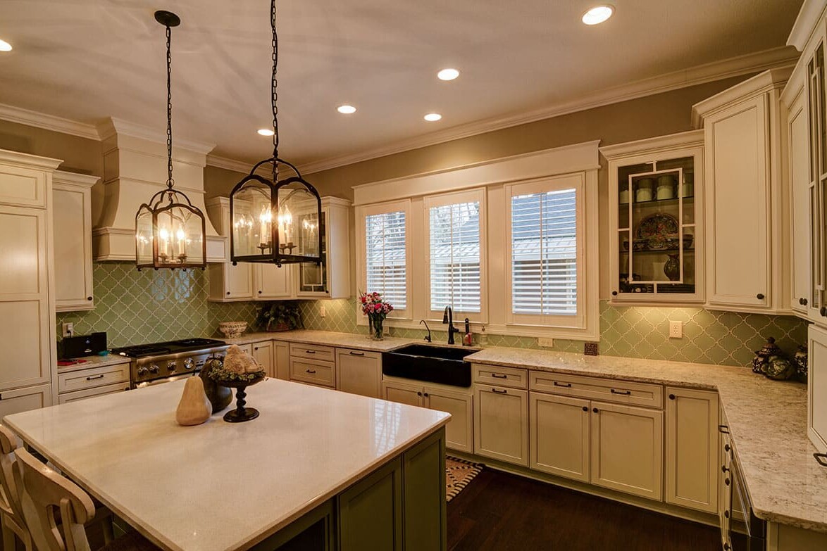 A kitchen with white cabinets and a center island, designed by a Custom Home Builder in Fishers Indiana.