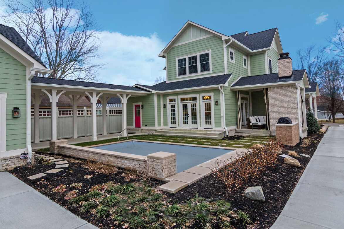 A custom home builder in Carmel Indiana creates a green house with a pool in the backyard for those seeking new homes.