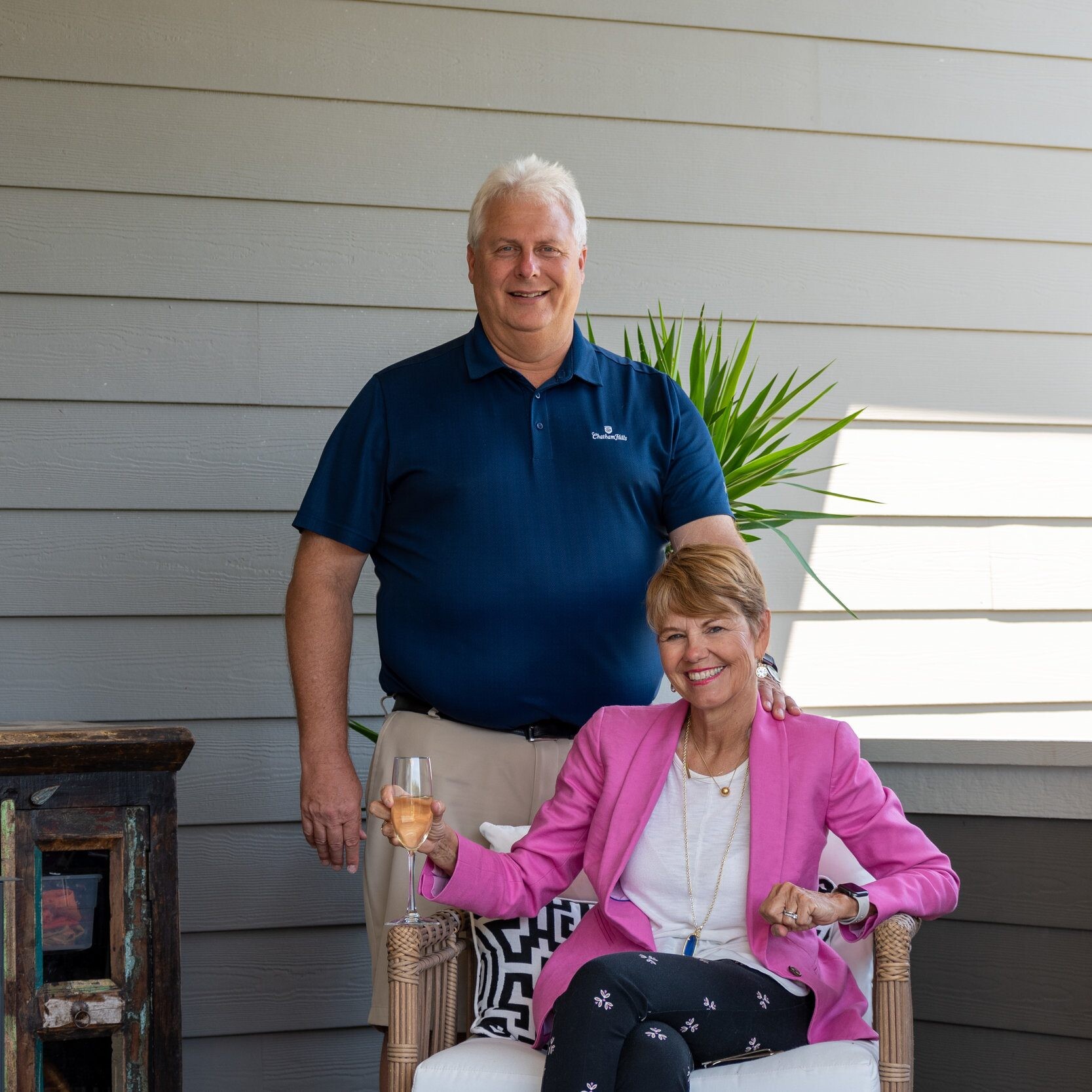A man and woman, enjoying the fresh air on a porch of their newly built custom home in Carmel, Indiana.