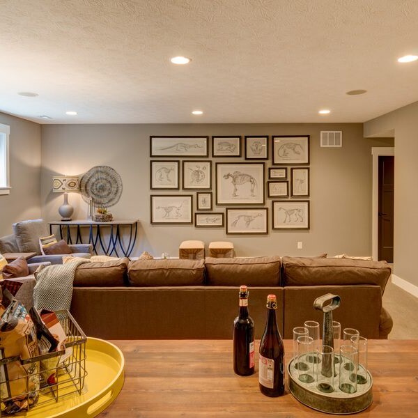 A luxurious living room featuring a coffee table adorned with a bottle of wine.