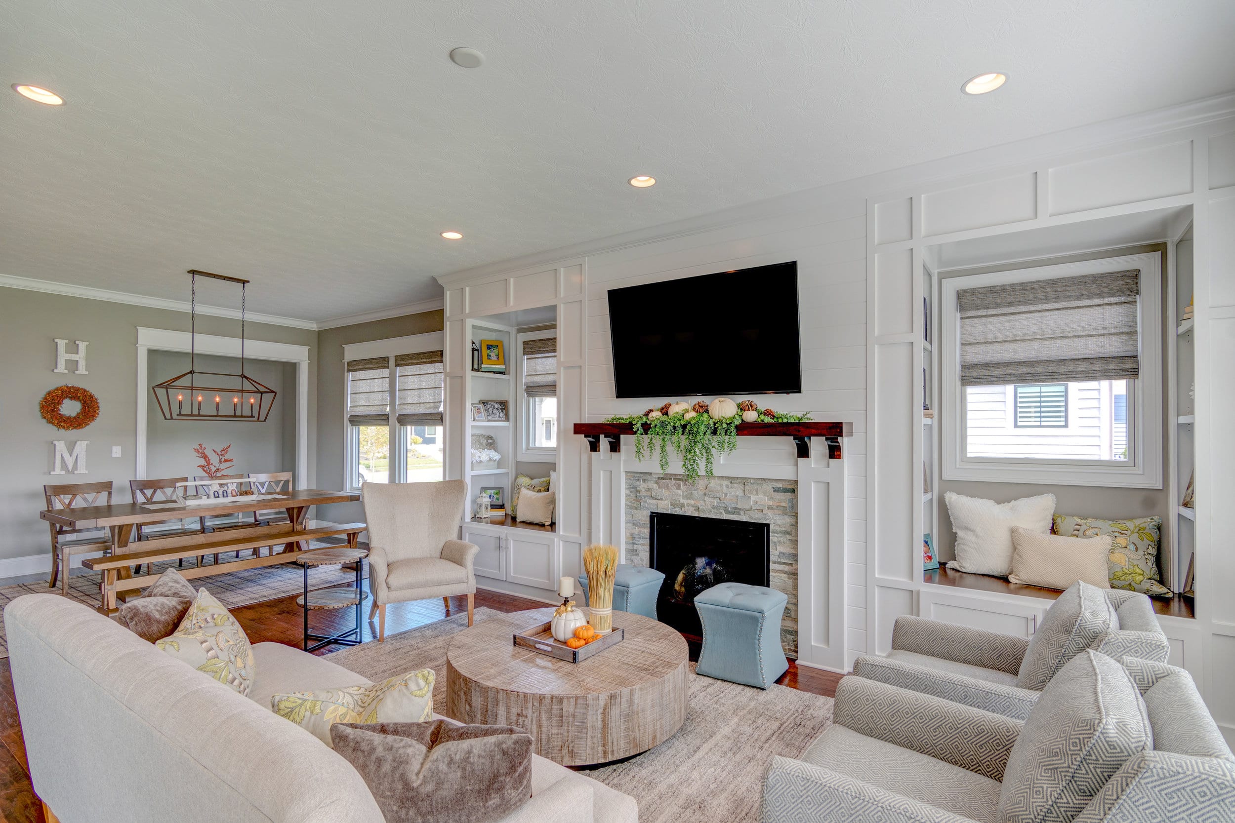 A custom-built living room with couches and a cozy fireplace in Fishers, Indiana.