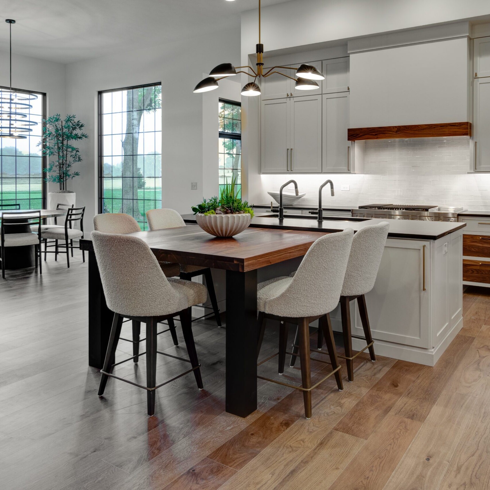 A kitchen with wood floors and a dining table.