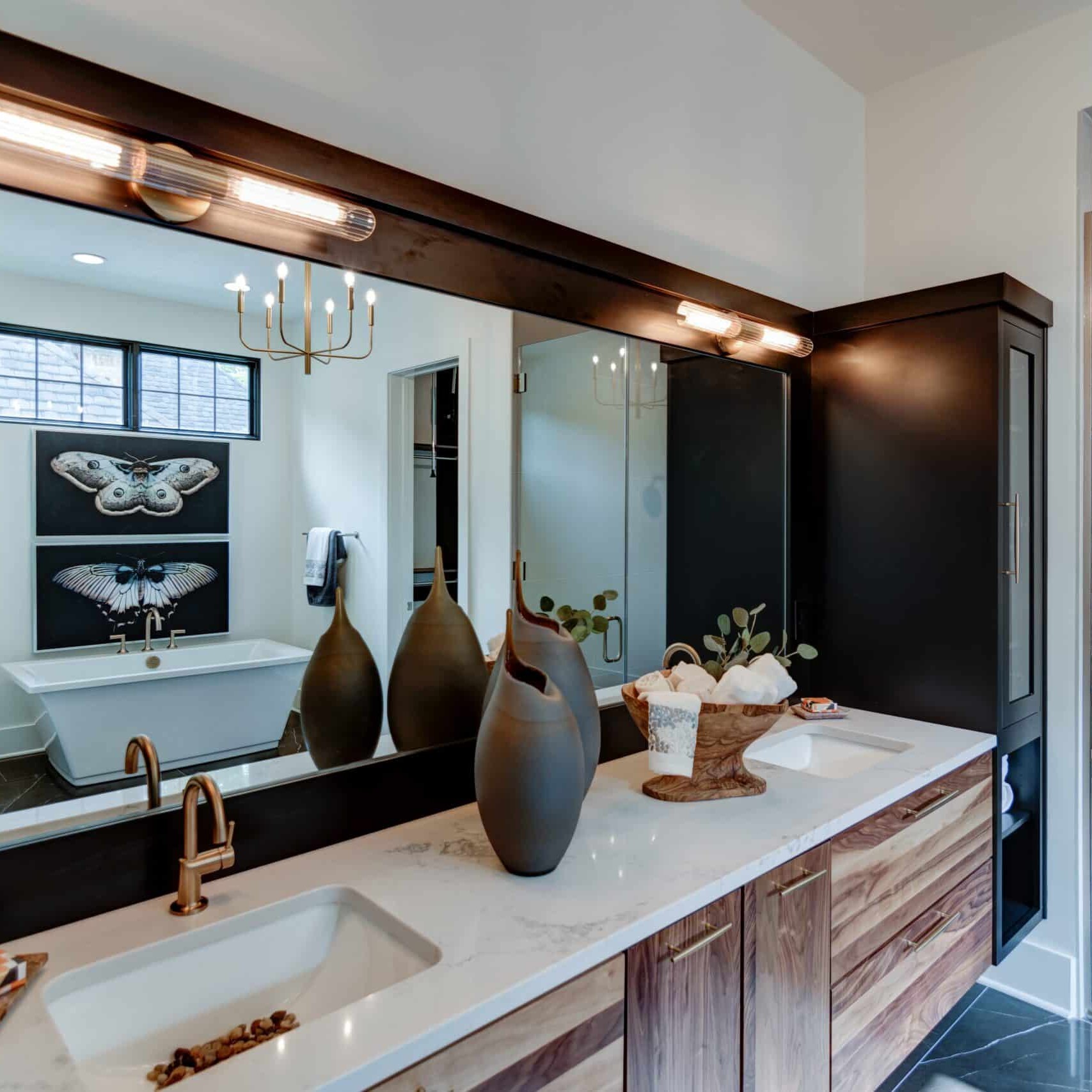 A bathroom with two sinks and a large mirror.