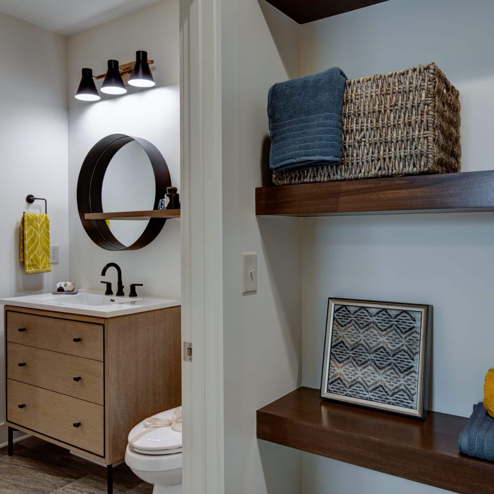 A bathroom with wooden shelves and a mirror.