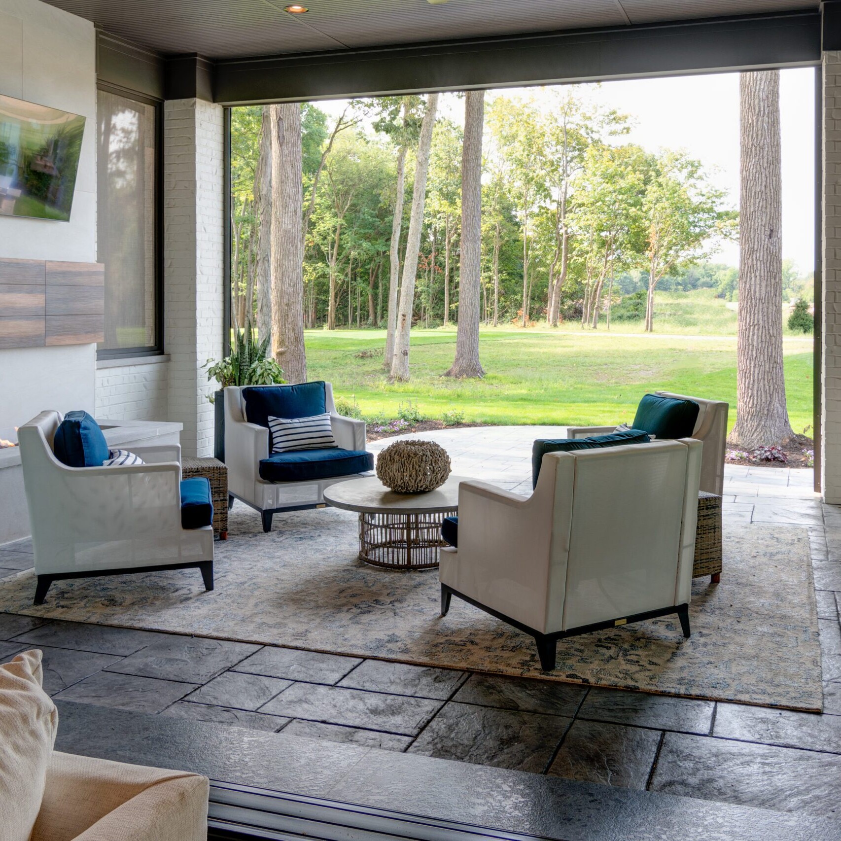 A living room with a fireplace and a sliding glass door.