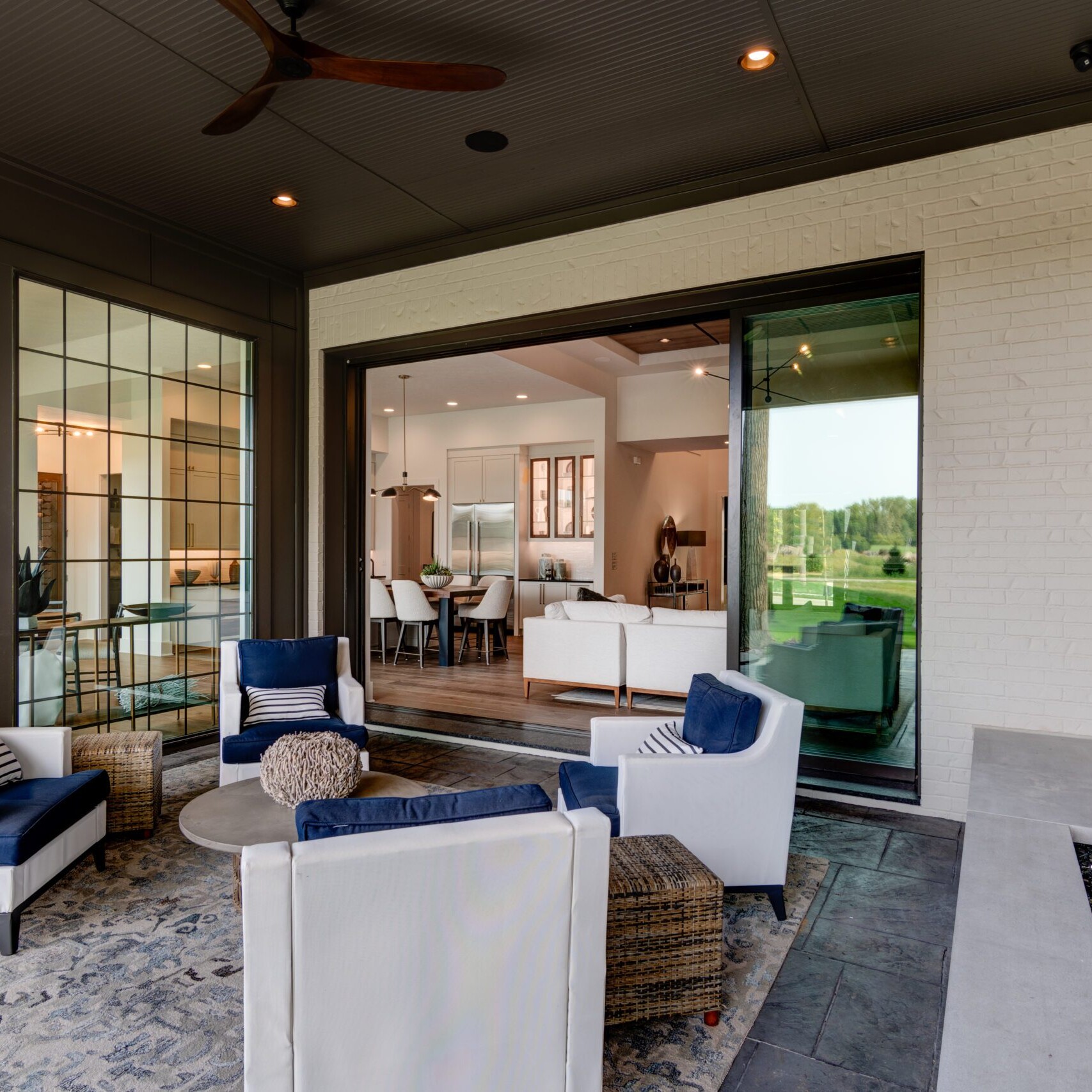 A living room with a fireplace and large windows.