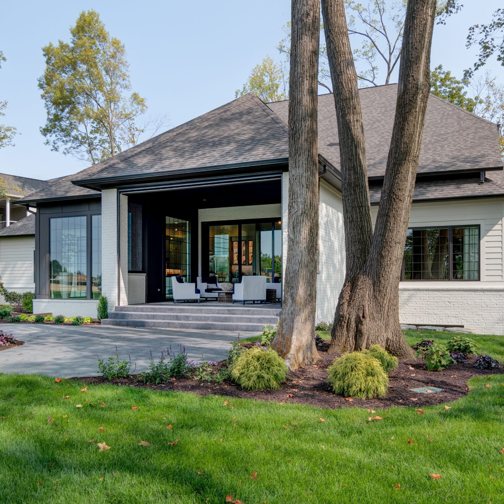 A home with a large yard and trees.