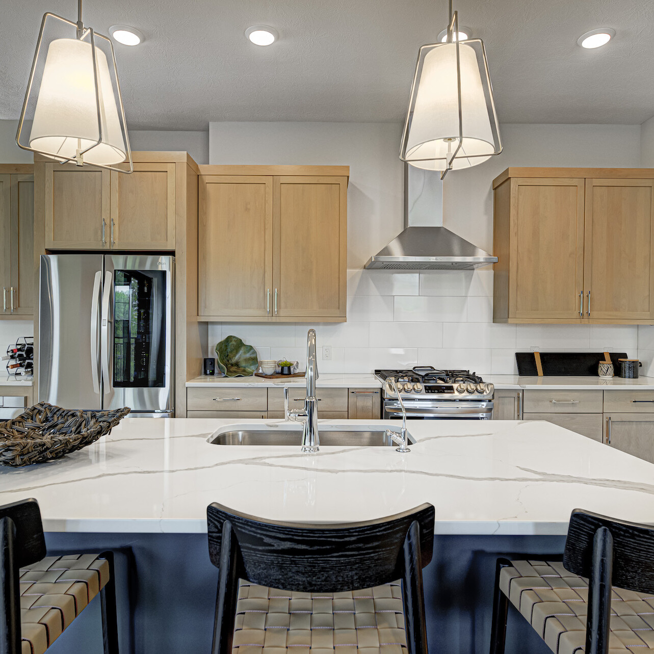 Indianapolis Custom Homes featuring a kitchen with a center island and stools.