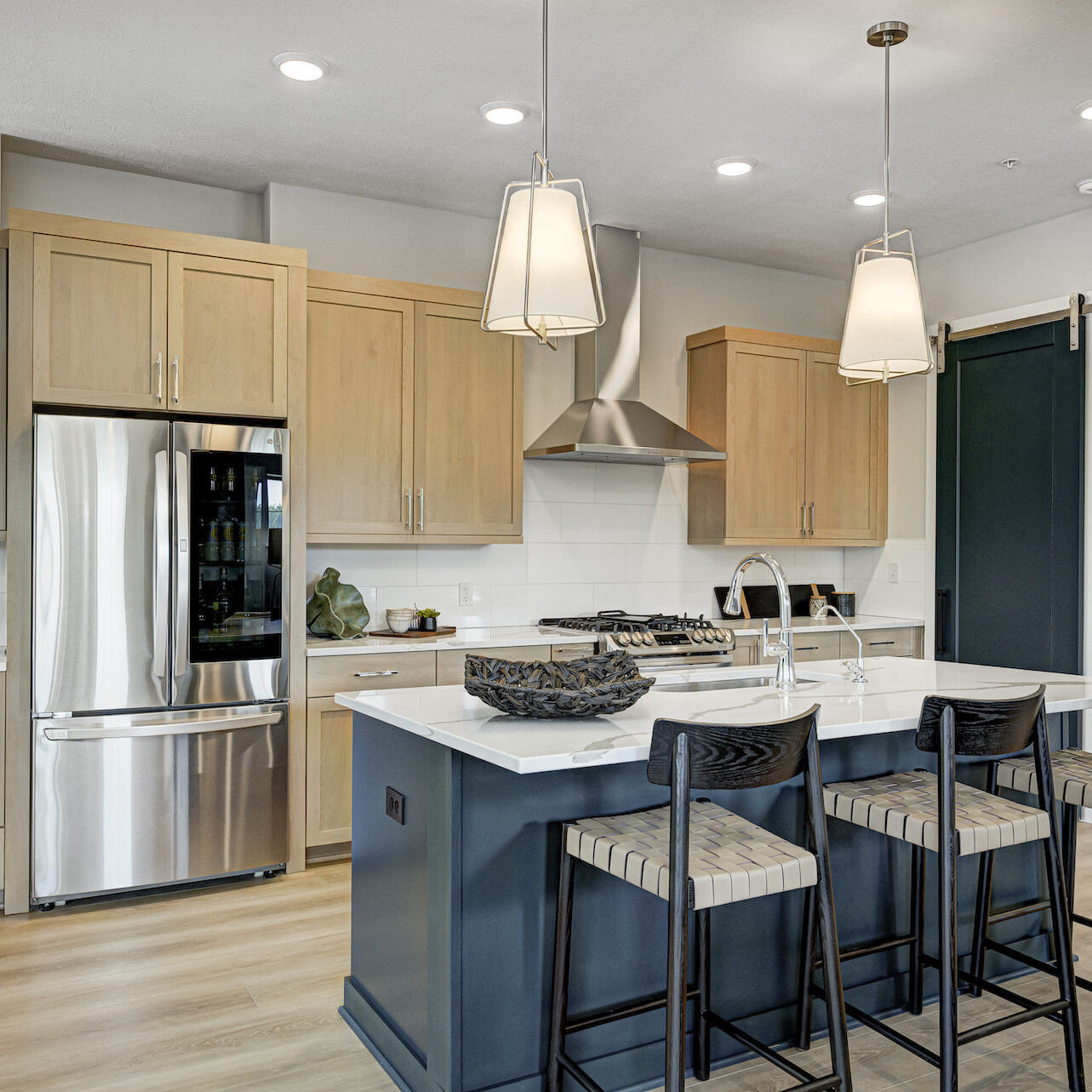 Custom Home Builder Carmel Indiana: A kitchen with a center island and bar stools.