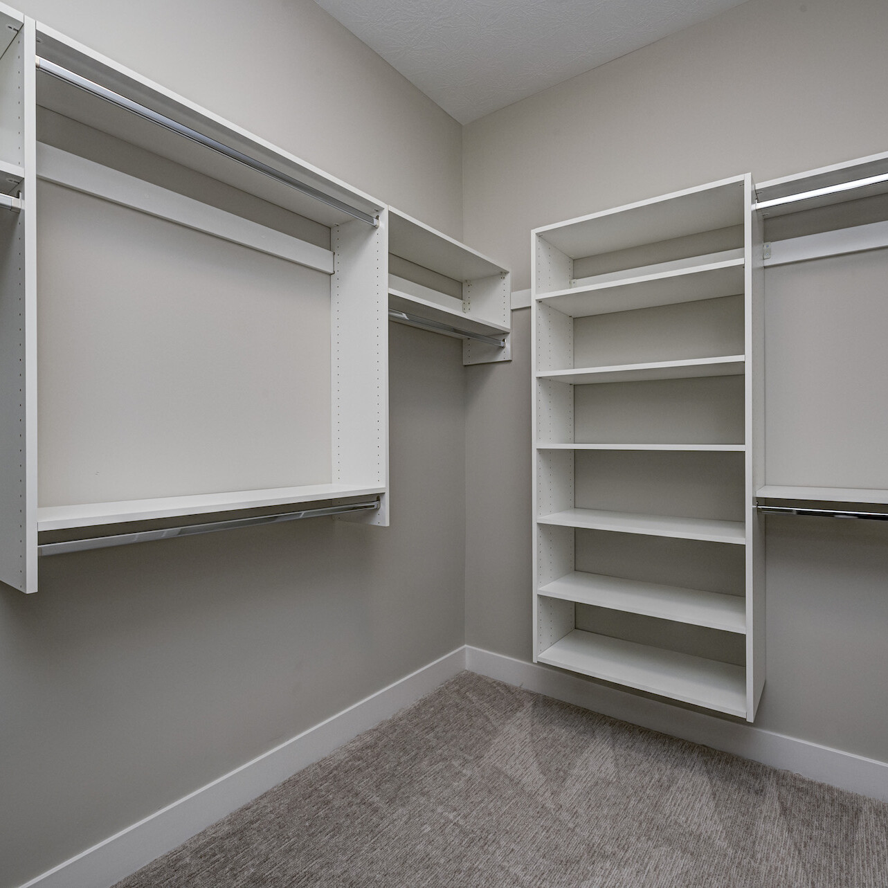 A walk-in closet with shelves and drawers, perfect for Custom Homes Westfield Indiana.