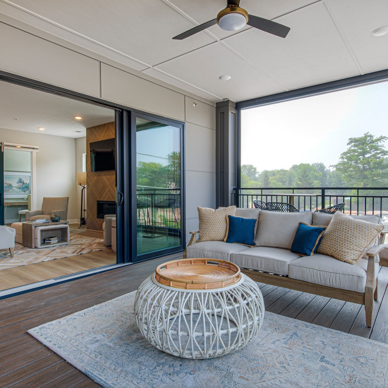 A custom home builder in Carmel Indiana creates a stunning living room with a sliding glass door, perfect for enjoying the new homes in Fishers Indiana.