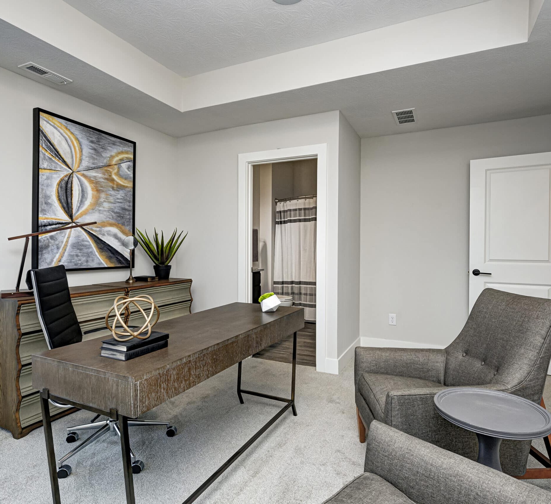 A modern home office furnished with a custom desk and chair.