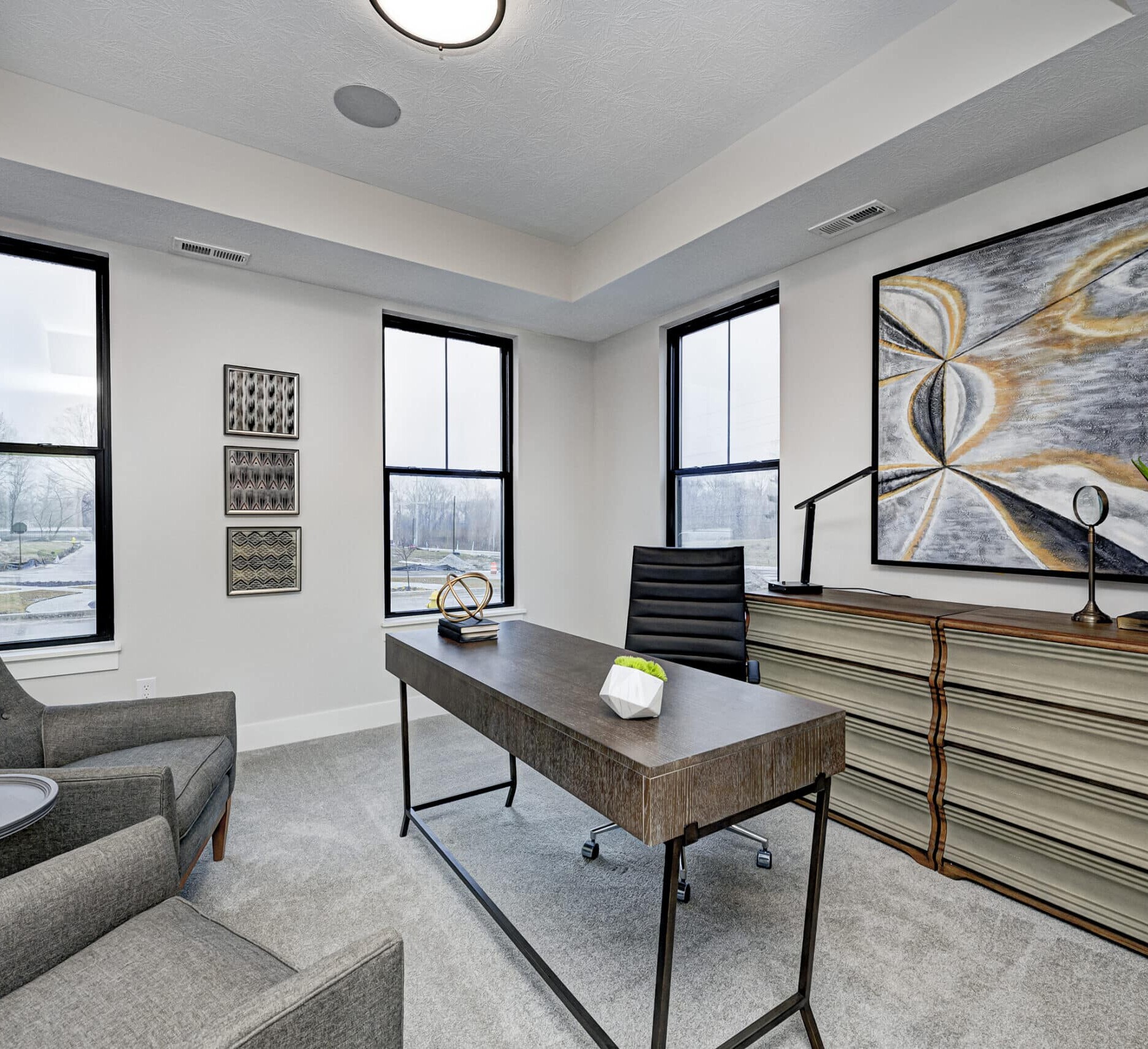 A home office with a desk and chair, designed and built by a reputable custom home builder in Indiana.