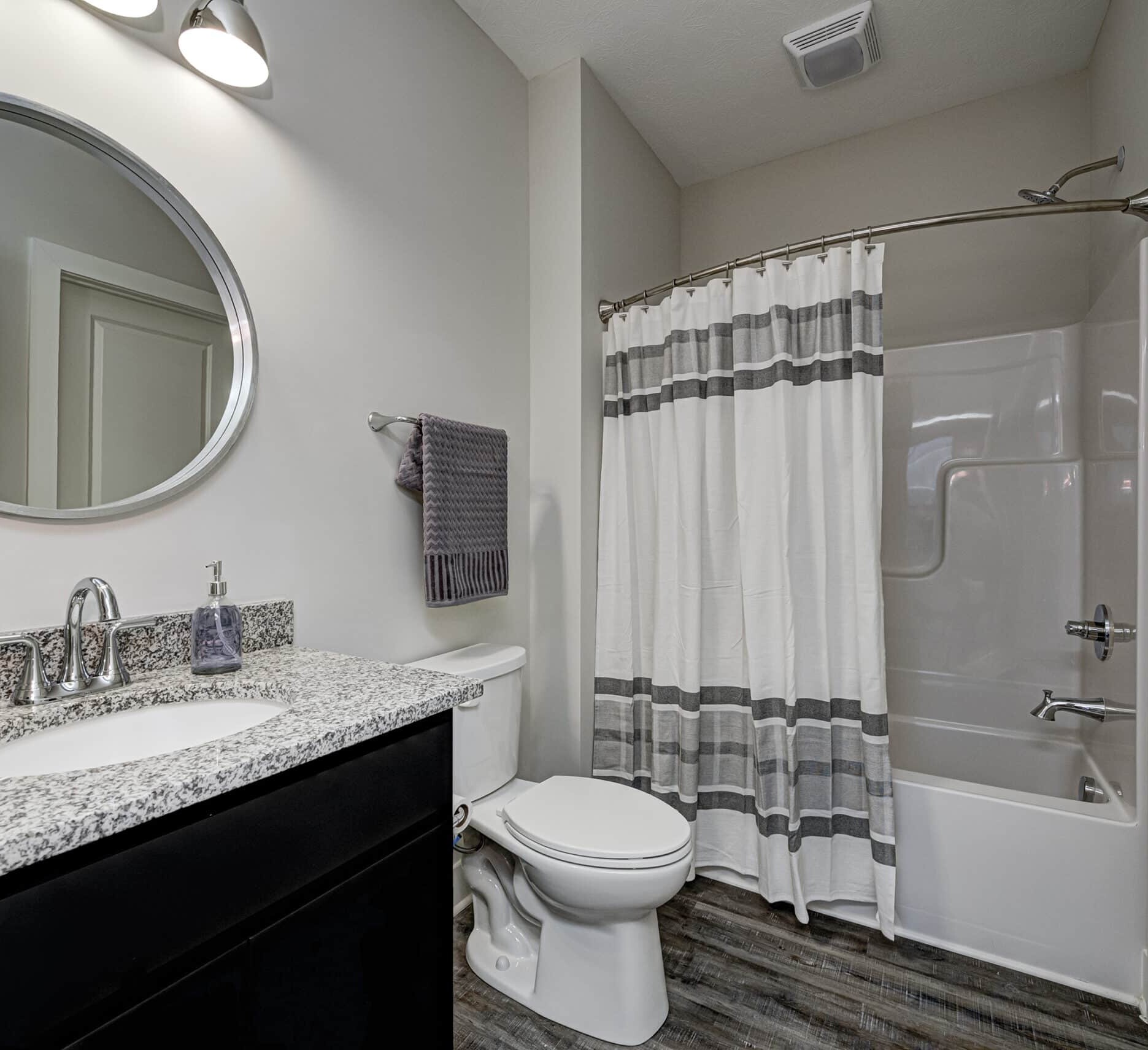 A custom bathroom with a shower, toilet and sink.